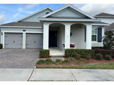 Two-story house with two car garage and landscaped front yard at 16368 Orange Seed Ln, Winter Garden, FL 34787