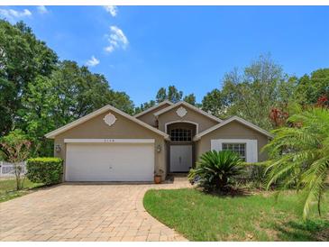 One-story house with a two-car garage and well-maintained landscaping at 2104 Cranberry Isles Way, Apopka, FL 32712