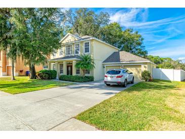 Two-story house with a driveway, garage, and landscaped lawn at 3442 Starbird Dr, Ocoee, FL 34761