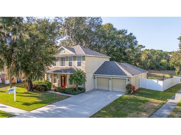 Two-story house with a two-car garage and manicured lawn at 3442 Starbird Dr, Ocoee, FL 34761