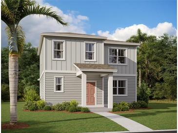 Two-story house with gray siding, red door, and landscaping at 2425 Zuni Rd, St Cloud, FL 34771