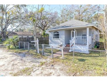 Charming gray brick home with a white porch and fenced yard at 330 W Jefferson W St, Daytona Beach, FL 32114