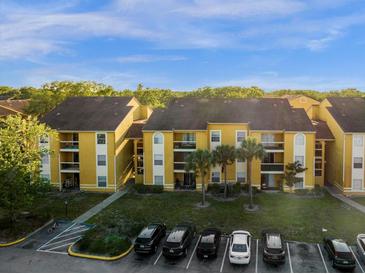 Aerial view of apartment buildings with parking and landscaping at 5271 Images Cir # 108, Kissimmee, FL 34746