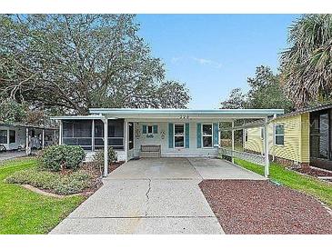 Single-story home with carport and landscaped yard at 228 Westwood Dr, Leesburg, FL 34748