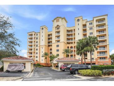 Elegant multi-story building with palm trees and gated entrance at 263 Minorca Beach Way # 301, New Smyrna Beach, FL 32169