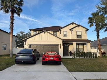 Two-story house with a modern facade, two-car garage, and manicured landscaping at 526 First Cape Coral Dr, Winter Garden, FL 34787