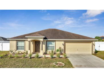 Charming one-story home with neutral paint, landscaped front yard, and an attached two-car garage at 1317 Conch Key Ln, Davenport, FL 33837