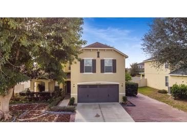 Inviting two-story home with a well-manicured yard and a convenient two-car garage at 2748 Pythagoras Cir, Ocoee, FL 34761