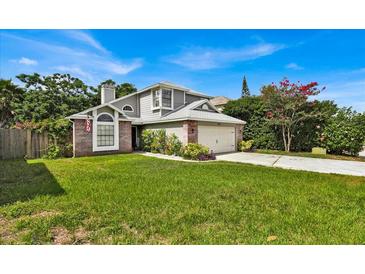 Two-story house with gray siding, brick accents, and a well-maintained lawn at 377 River Chase Dr, Orlando, FL 32807