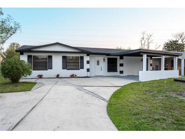 Charming single-story home featuring a well-manicured lawn, driveway, and welcoming entryway at 4658 Kirkland Blvd, Orlando, FL 32811