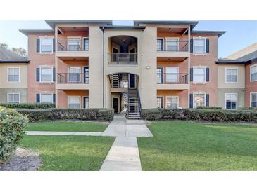 Two-story building exterior with balconies and landscaping at 5961 Westgate Dr # 2034, Orlando, FL 32835