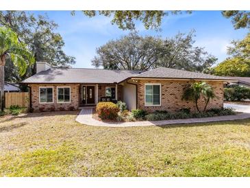 Brick house with landscaped lawn and walkway at 1107 Pheasant Cir, Winter Springs, FL 32708