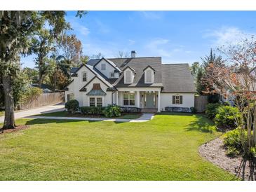 Two-story house with white exterior, gray roof, and landscaped lawn at 1470 Place Picardy, Winter Park, FL 32789