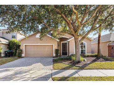 Attractive one-story home with a paved driveway and landscaping at 15319 Stonebriar Way, Orlando, FL 32826