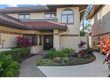 Inviting home exterior with landscaped walkway and charming entryway at 1812 Turnberry Ter, Orlando, FL 32804