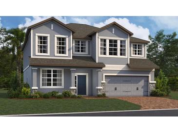 Two-story house with gray siding, brown trim, and a two-car garage at 5232 Prairie Preserve Run, St Cloud, FL 34772