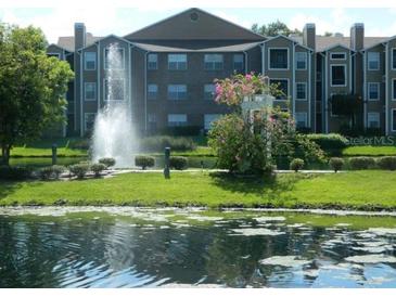 Apartment building with lake view and fountain at 5545 Devonbriar Way # 205, Orlando, FL 32822