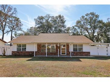 Brick ranch house with carport and fenced yard at 6616 Nw 60Th St, Ocala, FL 34482