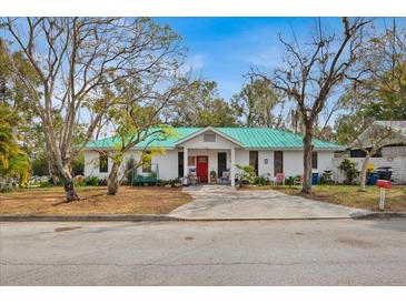 Charming single story home with a green metal roof and spacious yard at 750 S Dudley Ave, Bartow, FL 33830