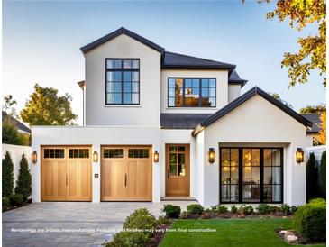 Stunning two-story home with black trim windows, a two-car garage, and a well-manicured lawn at 785 N Phelps Ave, Winter Park, FL 32789