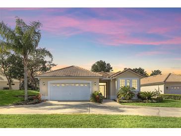 Attractive single-story home with a two-car garage and landscaped yard at 303 Foxhill Ct, Debary, FL 32713