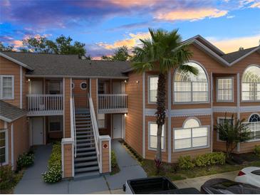 Two-story building exterior with stairs and palm tree at 3163 Britannia Blvd # D, Kissimmee, FL 34747