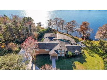 Stunning aerial view of lakefront property with pool and private dock at 491 Carolyn Dr, Oviedo, FL 32765