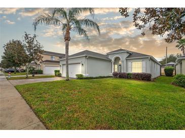 One-story home with a two-car garage and well-manicured lawn at 627 Copeland Dr, Haines City, FL 33844