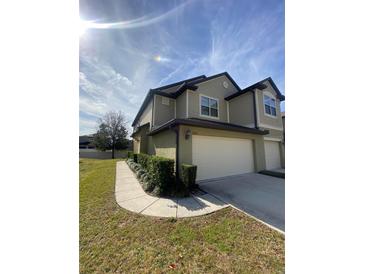 Two-story house with attached garage and landscaped front yard at 1100 Pavia Dr, Apopka, FL 32703