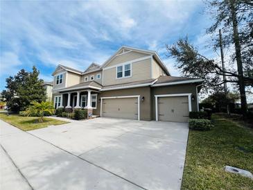 Two-story house with a three-car garage and landscaped yard at 2071 Remembrance Ave, St Cloud, FL 34769