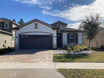 Beautiful house with a two-car garage and well-manicured lawn at 3010 Stonegate Dr, Ocoee, FL 34761