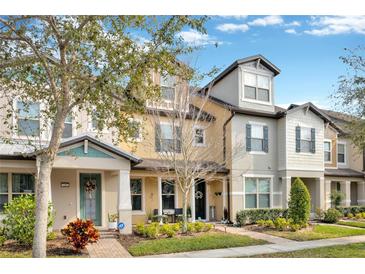 Attractive townhouses with landscaped yards and inviting front porches at 7387 Duxbury Ln, Winter Garden, FL 34787