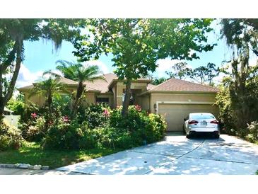 One-story house with a two-car garage and lush landscaping at 921 Rosinia Ct, Orlando, FL 32828