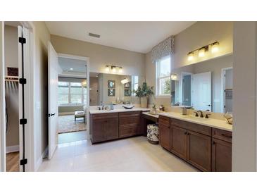 Spacious bathroom featuring double vanities, ample counter space, and a bright, open design at 987 Ladyfish Trl, St Cloud, FL 34771