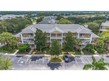 A stunning building exterior with private patios, lush landscaping and adjacent parking at 103 Rum Run # 103, Davenport, FL 33837