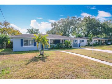 Light blue house with palm trees, walkway, and driveway at 1930 Albert Lee Pkwy, Winter Park, FL 32789