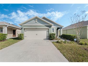 One-story house with a two-car garage and landscaped lawn at 866 Gunnison Dr, Orange City, FL 32763