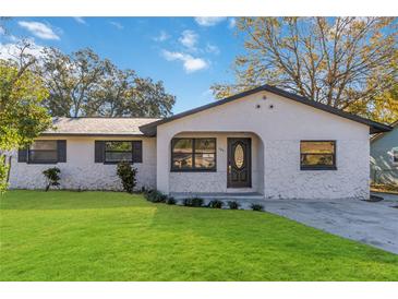 Newly renovated house with a stone facade and a well-manicured lawn at 137 Scott Dr, Sanford, FL 32771