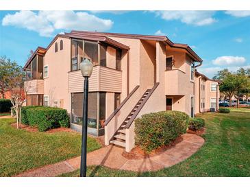 Inviting condo featuring private entrances and lush landscaping, offering a blend of comfort and curb appeal at 2935 Antique Oaks Cir # 64, Winter Park, FL 32792