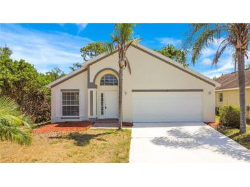 Charming single-story home featuring a two-car garage, arched entryway, and well-maintained landscaping at 441 Tree Shore Dr, Orlando, FL 32825