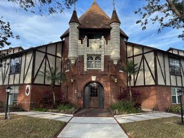 Brick building exterior with turrets and a courtyard entrance at 5413 Hansel Ave # K10, Orlando, FL 32809