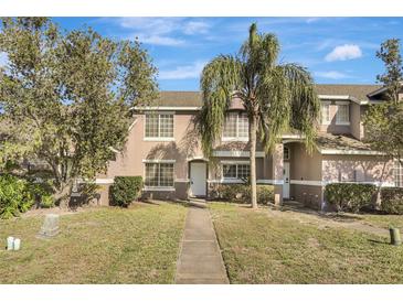Two-story townhome with a landscaped yard and walkway at 1135 Madeira Key Way Way, Orlando, FL 32824