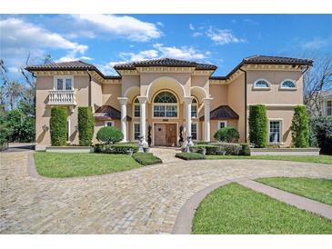 Grand two-story home with stone driveway and manicured landscaping at 125 Stone Hill Dr, Maitland, FL 32751