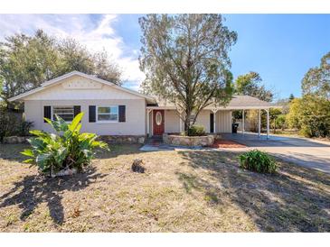 Charming single-story home with a well-manicured front yard and a cozy carport at 5112 Londonderry Blvd, Orlando, FL 32808