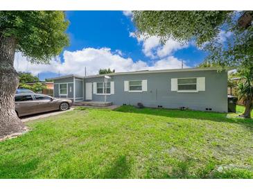 Gray house with a green lawn and driveway, parked car visible at 901 S Solandra Dr, Orlando, FL 32807