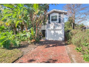 Two-story house with brick driveway and lush landscaping at 816 Laurel Ave # 1, Orlando, FL 32803