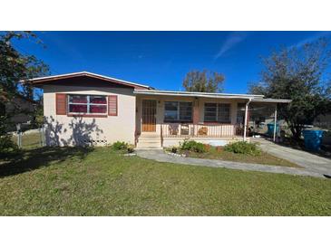 Cute ranch home with a covered porch and well-maintained lawn at 2035 W Gore St, Orlando, FL 32805