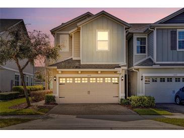 Two-story townhome with attached garage and landscaped front yard at 1008 E 10Th St, Apopka, FL 32703