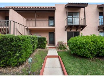 Front view of condo building with walkway and landscaping at 230 La Casa # 230, Lake Wales, FL 33898
