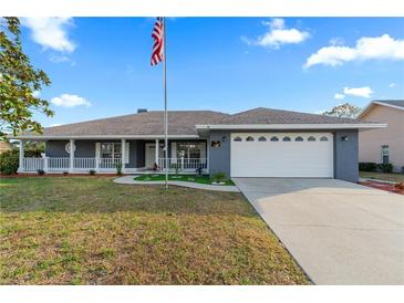 Charming single Gathering home featuring a two car garage, manicured lawn and inviting front porch at 657 Hunters Run Blvd, Lakeland, FL 33809